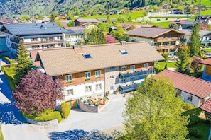 A multi-story building with a central courtyard, surrounded by trees and other buildings. - in the holiday home Antonia (Dorfgastein)