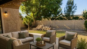 An outdoor patio with wicker furniture, a coffee table, and a potted plant. - Charming 3 bed 3 bath gated community w/ office, large chefs kitchen & laundry (Chandler)