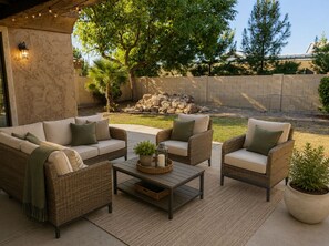 An outdoor patio with wicker furniture, a coffee table, and a potted plant. - Charming 3 bed 3 bath gated community w/ office, large chefs kitchen & laundry (Chandler)