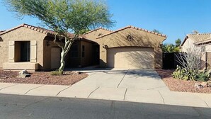 A residential house with a garage, a driveway, and a tree in the front yard. - Charming 3 bed 3 bath gated community w/ office, large chefs kitchen & laundry (Chandler)