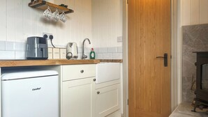 A compact kitchen with a coffee maker, tea maker, and a small fridge. - Spring Meadow Shepherds Hut (Rowrah)