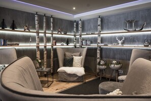 Ein modernes Wohnzimmer mit Kamin, Sofa, Couchtisch und Bücherregal.