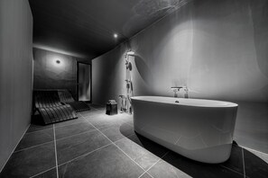 A modern bathroom with a freestanding bathtub, a shower, and a bench. - THE DWBL HOTEL B (Otaru)