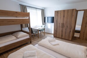 A room with bunk beds, a desk, a chair, a wardrobe, and a mirror. - Holiday home on the ski slope with sauna (St. Lambrecht)