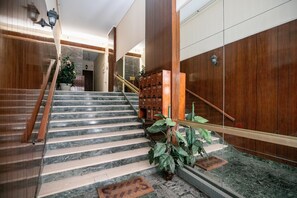 A marble staircase with wooden handrails, a potted plant, and a mailbox. - Sylka - Warm 1-BR & Balcony in Athens (Athens)