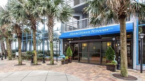 A building with a blue awning labeled 'SeaGlass Tower' and a glass facade. - Oceanfront 1BR Deluxe at SeaGlass Tower – Myrtle Beach Views & Resort Pools (Myrtle Beach)