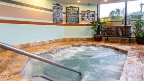 A hot tub with a metal railing, surrounded by stone tiles and potted plants. - Oceanfront 1BR Deluxe at SeaGlass Tower – Myrtle Beach Views & Resort Pools (Myrtle Beach)