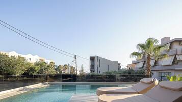 Seasonal outdoor pool, pool umbrellas, pool loungers