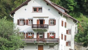 A multi-story building with a balcony, a door, and a window. - Chasa Soldanella, (Tarasp) by Interhome (Tarasp)