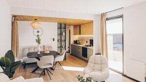 A modern interior with a dining area, kitchen, and seating space.