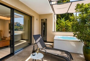 A modern outdoor area with a glass door leading to a pool, a lounge chair, a small table with a bottle and glass, and a large potted plant. - Luce Suite -Taormina In Light Suites (Taormina)