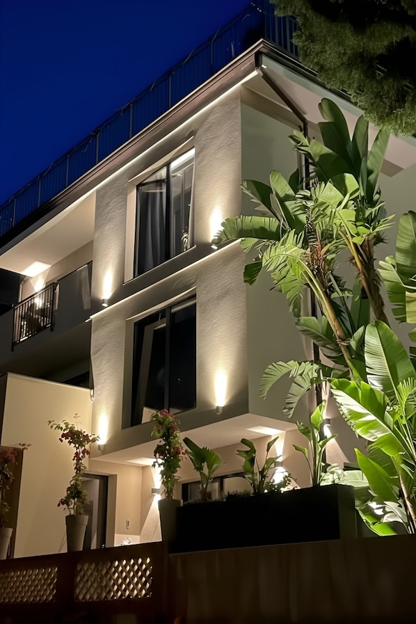 A modern two-story building with balconies, large windows, and potted plants. - Alba Suite-Taormina In Light Suite (Taormina)