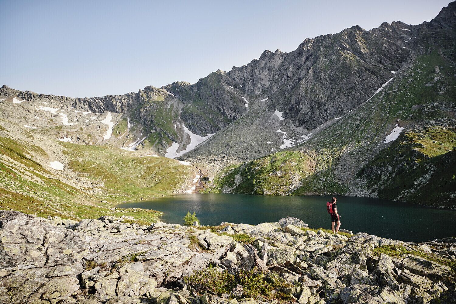 A mountainous landscape with a lake and rocky terrain.
