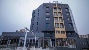 A multi-story hotel with a prominent 'EUROPECA' sign, large windows, and outdoor seating area.