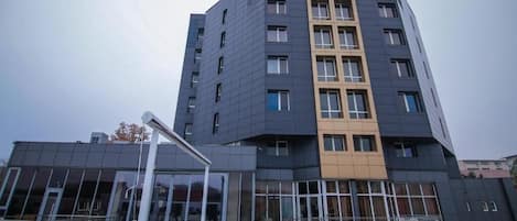 A multi-story hotel with a prominent 'EUROPECA' sign, large windows, and outdoor seating area.