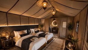 A tented room with two beds, a nightstand, a vanity, and a mirror. - Sultan Luxury Camp  (Merzouga)
