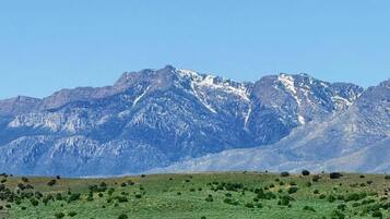 A coastal landscape with mountains in the background.