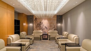 A room with a modern chandelier, a large wall mural, and multiple seating areas. - Shaanxi Normal University International Education Building (Xi'an)