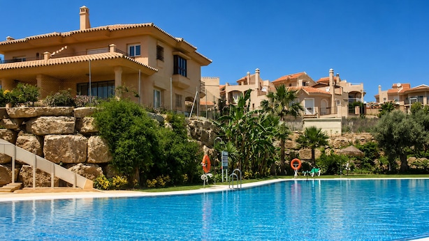 A swimming pool with a clear blue water, surrounded by a stone wall and greenery. - Awesome home in Mijas with swimming pool (Mijas)