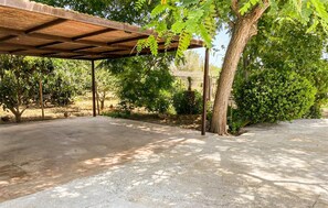 A covered outdoor area with a concrete floor, surrounded by trees and greenery. - Gorgeous home in Artà with private swimming pool, can be inside or outside (Artà)