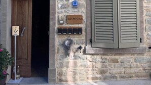 A stone building with a wooden door, shutters, and a sign reading 'Café Mie.' - Cà Maina (Santa Sofia)
