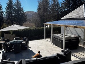 A patio with outdoor furniture, a barbecue grill, and a pergola with solar panels. - 1 Station Cottages (Pitlochry)