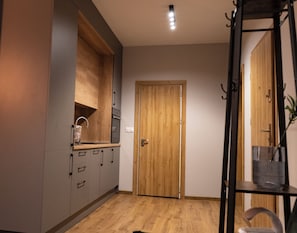 A kitchen with wooden cabinets, a built-in oven, and a door.
