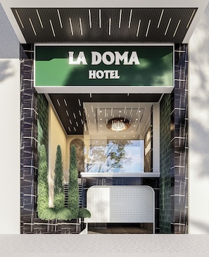 The exterior of La Doma Hotel with a prominent sign, a modern entrance, and a view of the interior through the glass facade. - La Doma Hotel-Airport Serviced Residence (Tan Son Hoa)