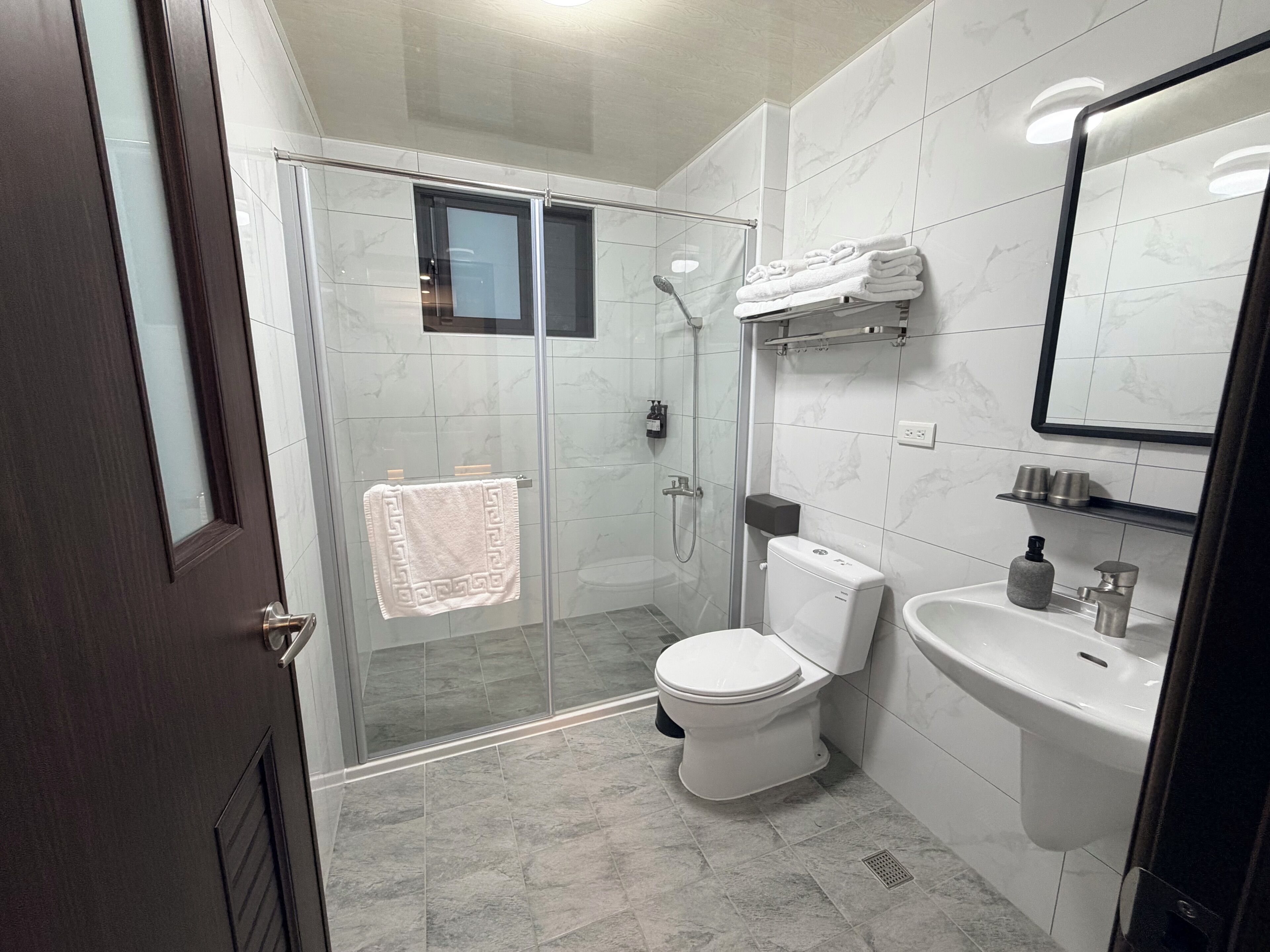 Shower, hair dryer, slippers, towels