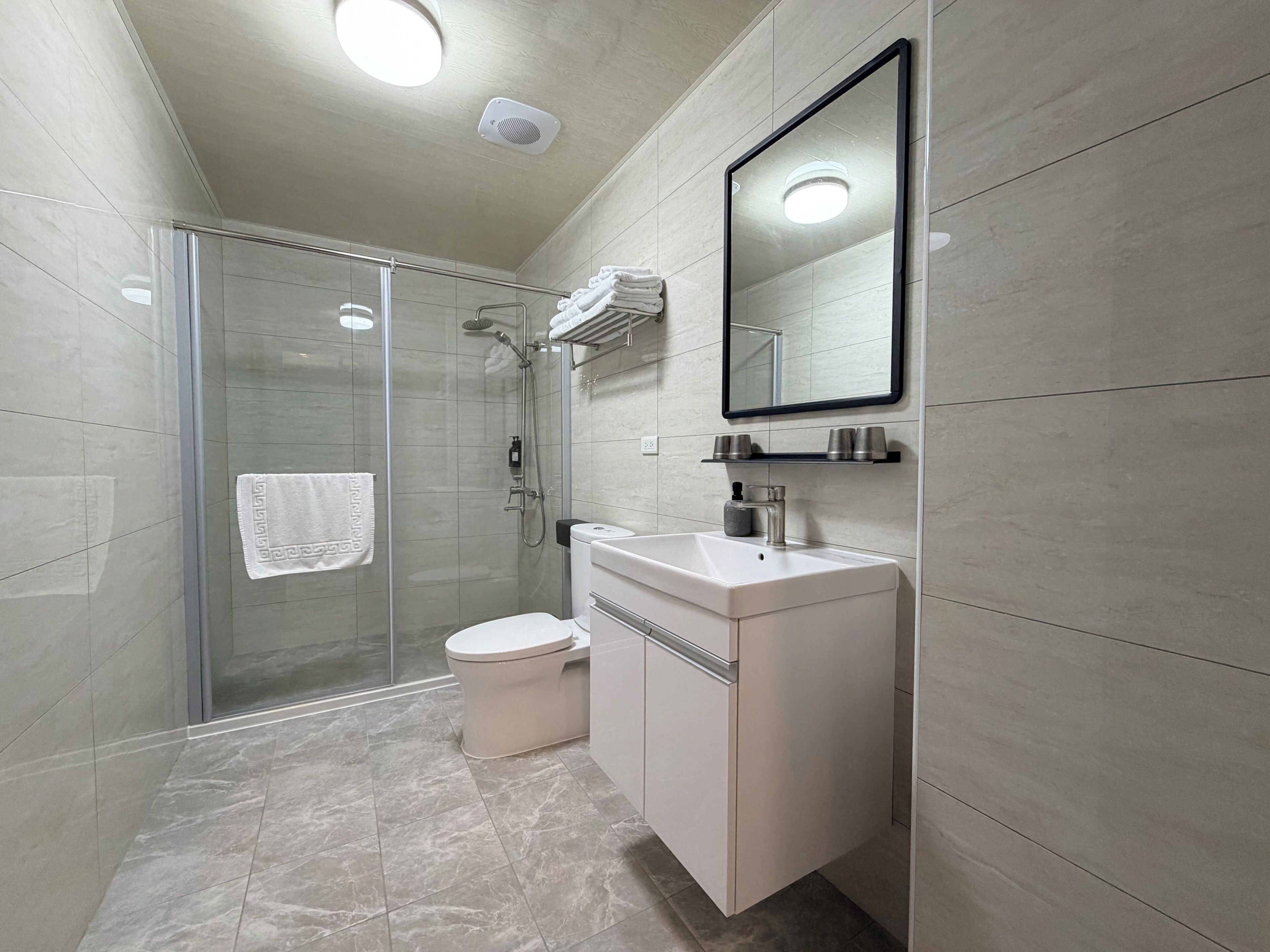 Shower, hair dryer, slippers, towels