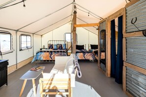 A tented accommodation with two beds, a table, and a chair. - Old Western Glamping Vacation in Tombstone, Arizona (Tombstone)