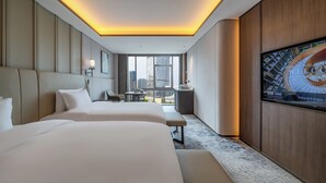 A hotel room with two beds, a TV, and a city view. - International Hotel LuoYang (Luoyang)
