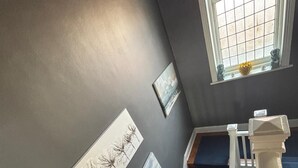 A staircase with a dark wall and a window with a view. - Herbert House (Cape Town)