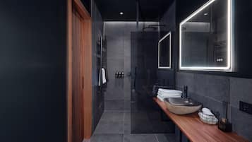 Un baño moderno con tocador de madera, un espejo grande y un lavabo empotrado.