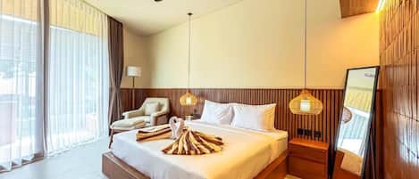 A hotel room with a large bed, a ceiling fan, a nightstand, a lamp, and a view of the outdoors.
