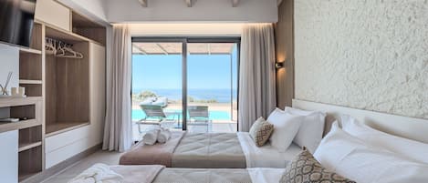 A bedroom with two beds, a wardrobe, a large window with a view of the sea, and a ceiling with wooden beams.