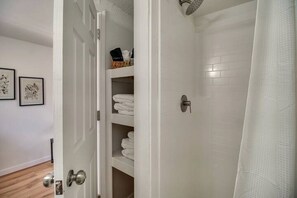 A bathroom with a shower, a toilet, and a sink. - Cozy Studio Retreat with Scenic 5-Acre Views, Near City Lake & Cherokee Casino in Gentry, Arkansas (Gentry)