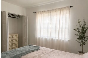 A bedroom with a bed, a dresser, a closet, and a window with sheer curtains. - Perfect 3-bedroom house with AC in awesome St. Petersburg (St. Petersburg)