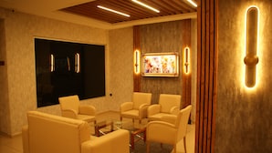 A modern living room with a sofa set, a coffee table, and a television.