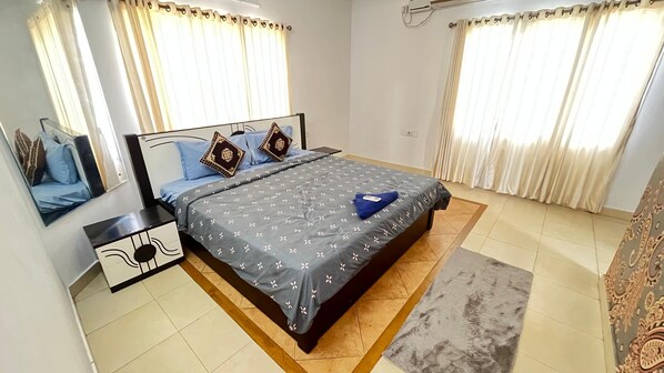 A neatly arranged bedroom with a bed, nightstands, and a rug.