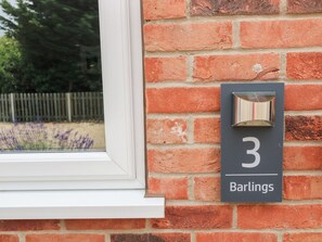 A brick wall with a number '3' and the name 'Barlings' indicating a property or location. - Walcott Lodges - Barlings (Lincoln)