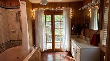 A bathroom with a bathtub, toilet, sink, and shower.