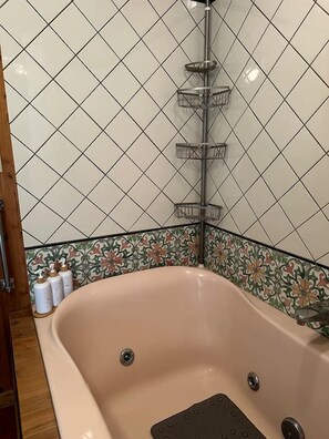 A bathroom with a freestanding bathtub, a shower column, and a decorative tile backsplash. - Hidden Countryside Gem with Fire Pit & Tranquil Setting in Aspers, Pennsylvania (Aspers)