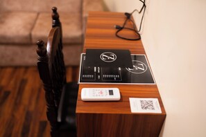 A wooden desk with a black tray, a white electronic device, and a QR code. - Z Cafe and Apartment (Kathmandu)