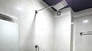 A bathroom with a sink, toilet, shower, and a ceiling light. - Z Cafe and Apartment (Kathmandu)