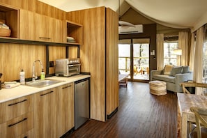 A compact kitchen with wooden cabinets, a built-in oven, and a dishwasher.