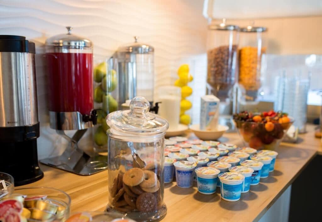 A buffet setup with various food items and beverages.