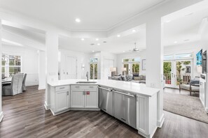 A modern kitchen with white cabinetry, stainless steel appliances, and a large island. - Le Destin Gulf Views Private Pool Private Beach (Miramar Beach)