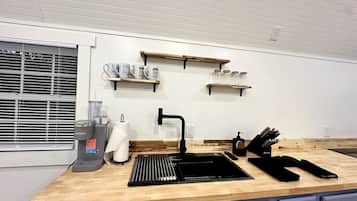 Fridge, microwave, coffee/tea maker, cookware/dishes/utensils