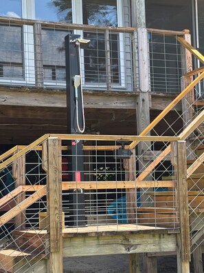 A wooden staircase with a metal railing leading to a second-floor balcony. - Lake Wateree Retreat,Private Dock, Fire Pit,Kayaks,Sunset glow views, sleeps 6 (Ridgeway)